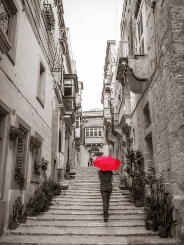 Assaf Frank - Tourist with umbrella in steps through houses in Birgu, Malta