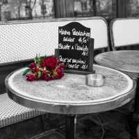 Assaf Frank - Bunch of flowers on sidewalk cafe table, Paris, France