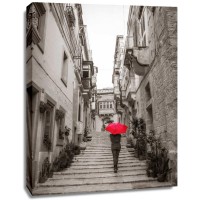 Assaf Frank - Tourist with umbrella in steps through houses in Birgu, Malta